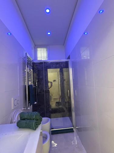 a bathroom with two toilets and a shower with purple lighting at Milanino in Cusano Milanino