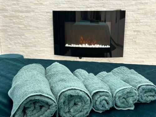 a pile of rolled towels in front of a fireplace at Milanino in Cusano Milanino