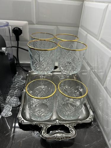 a tray with four wine glasses on it at Milanino in Cusano Milanino