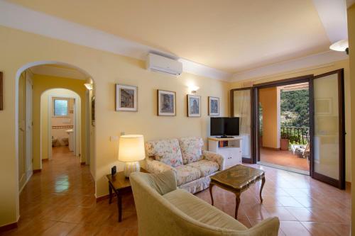 a living room with a couch and a tv at Casa Le Terrazze in Positano