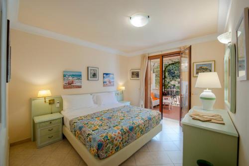 a bedroom with a bed and a table with a lamp at Casa Le Terrazze in Positano
