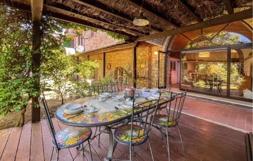 a table with chairs and cups and plates on a patio at Pet Friendly Home In Cetona in Cetona