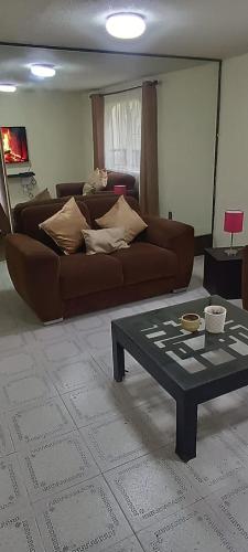 a living room with a couch and a coffee table at departamento tranquilo in Mexico City
