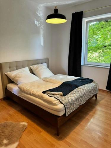 a bed sitting in a room with a window at Casa Grande in Duisburg