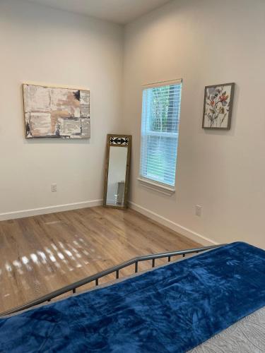 a room with a bed and a mirror at New Home in Lockhart with a Groovy Lounge in Lockhart