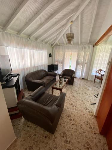 a living room with a couch and a table at Villa Ligia in Medellín