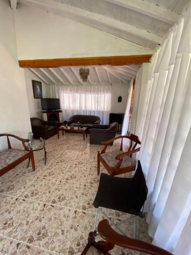 a living room with chairs and a couch at Villa Ligia in Medellín