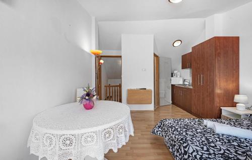 a room with a table with a vase on it at Stunning Apartment In Vodice in Vodice