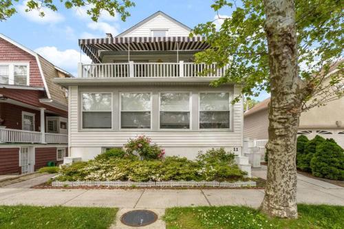 a white house with a balcony on top of it at 5BR 3BA Family Retreat 2 Blocks from Beach in Atlantic City