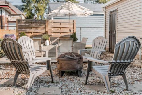 a group of chairs and a grill with an umbrella at Chic 1BR Retreat with Sofa Bed, Free Parking in Indianapolis