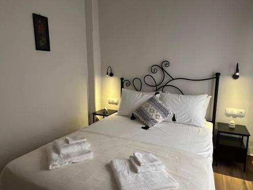 a bedroom with a white bed with towels on it at Mirodaty's House in Rhodes Town