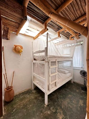 a bedroom with a bunk bed in a room at KUA Cabañas in Palomino