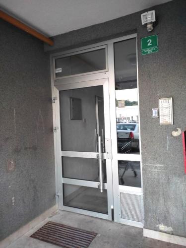 an entrance to a building with a glass door at 4th Floor Apartment in Sarajevo