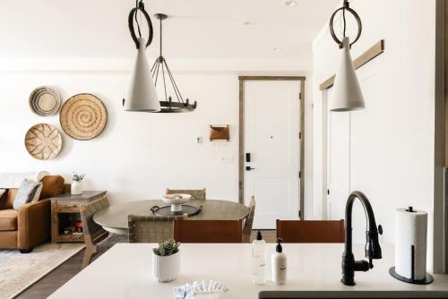 a kitchen and living room with white walls at New Luxe Condo - Hot Tub - Minutes to WP! - Fraser in Fraser