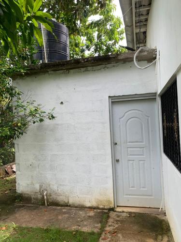 a garage with a white door next to a building at Villa Piña Alojamiento rural in San Rafael