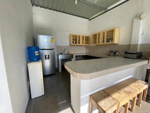 a kitchen with a refrigerator and a counter top at Casa de Huespedes "Darling" in Puerto Baquerizo Moreno
