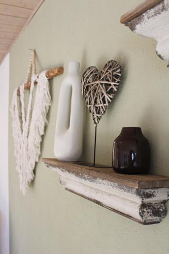 a shelf with two vases and a heart on it at Der Eulenschlupf in Ühlingen-Birkendorf