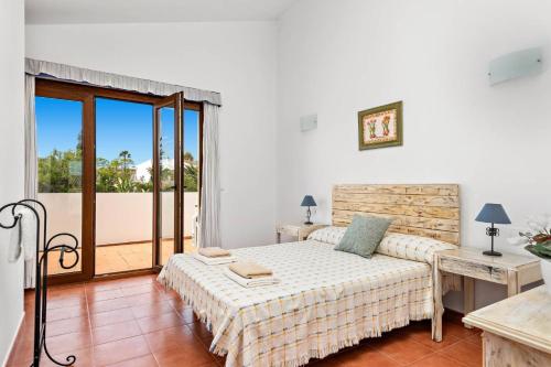 a bedroom with a bed and a balcony at Villa Angel by Villa Plus in Son Xoriguer