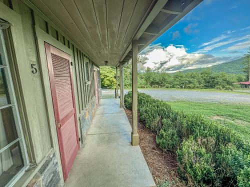 a porch of a house with a red door at Hemlock Inn in Bryson City