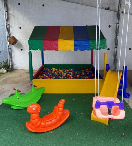 a play room with a playground with different kinds of toys at Casa do Pinheiro Petrópolis in Petrópolis