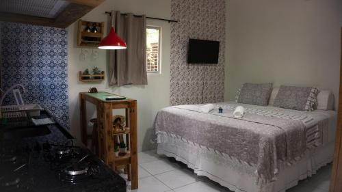 a bedroom with a bed and a window at Pousada Viana in Garanhuns