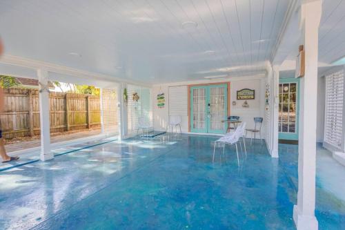 an indoor pool with blue flooring in a house at 2BR at Lecom Park Downtown Beaches & Ample Parking Space in Bradenton
