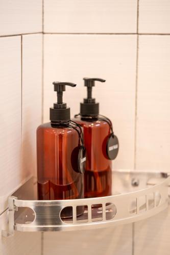 two fire hydrants on a shelf in a bathroom at Titeng Guest House - Comfortable studio in amazing location near Potato Head and the beach in Seminyak