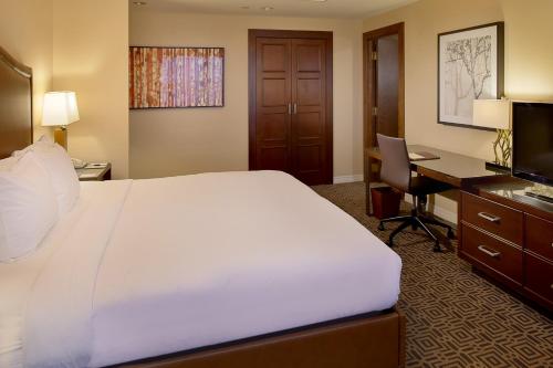a hotel room with a large bed and a desk at DoubleTree by Hilton Hotel St. Louis - Chesterfield in Chesterfield