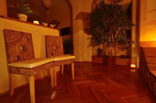 a chair in a room with a wooden floor at Wellness Apartment De Luxe in Liberec