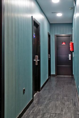 a hallway with two doors and a fire hydrant at JC Rooms Santo Domingo in Madrid
