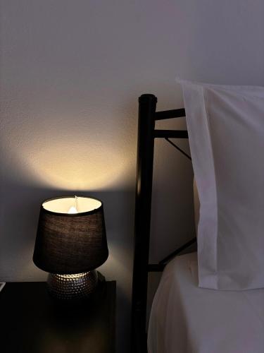 a lamp sitting on a table next to a bed at Kanelli΄s apartments in Monemvasia