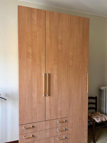 a large wooden cabinet in a living room at Locazione Turistica San Vigo in Vigasio