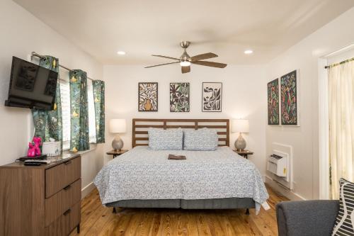 a bedroom with a bed and a flat screen tv at The Speakeasy Inn and Rum Bar in Key West