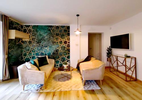 a living room with two chairs and a wall at City Vendégház Balatonfüred in Balatonfüred