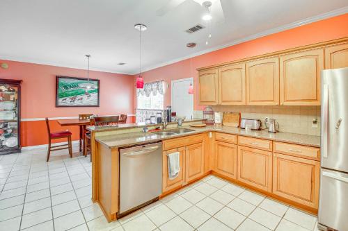 a kitchen with orange walls and wooden cabinets at Beautiful Home Less Than 1 Mi to Hot Springs National Park in Hot Springs