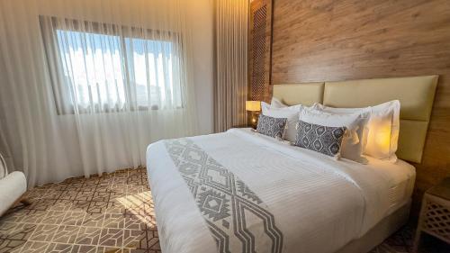 Postel nebo postele na pokoji v ubytování فندق ايليت الهجرة Elite AL Hijra Hotel