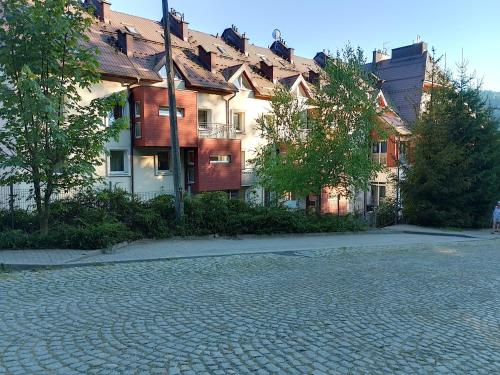 a cobblestone street in front of a building at Apartament Alias in Wisła
