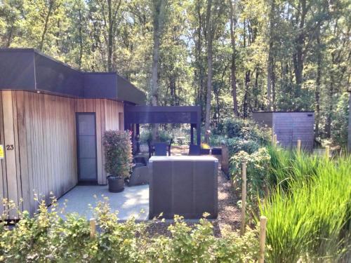 a house in the middle of a garden at Theressa - Free Wifi en Netflix in Zutendaal