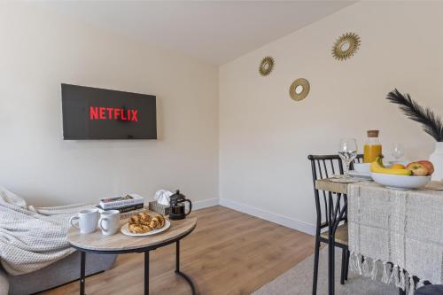 a living room with a table with food on it at 2 Bed Flat - Gatwick Airport - FREE PARKING in Redhill