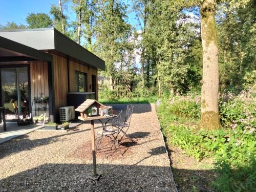 a bird house on a table in front of a house at Theressa - Free Wifi en Netflix in Zutendaal