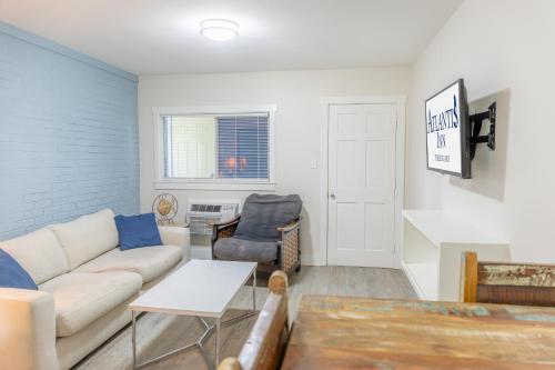 a living room with a couch and a table at Atlantis Inn - Tybee Island in Tybee Island
