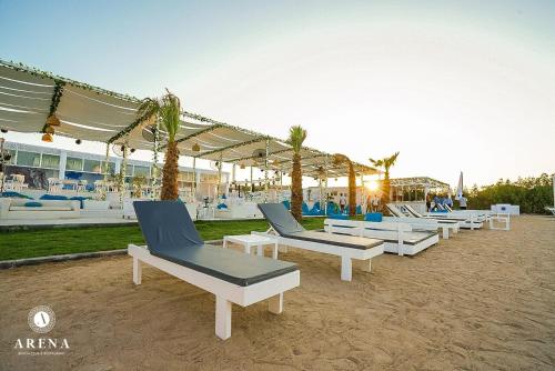 a row of chaise lounges on a beach at comfort marine 2 in Hurghada