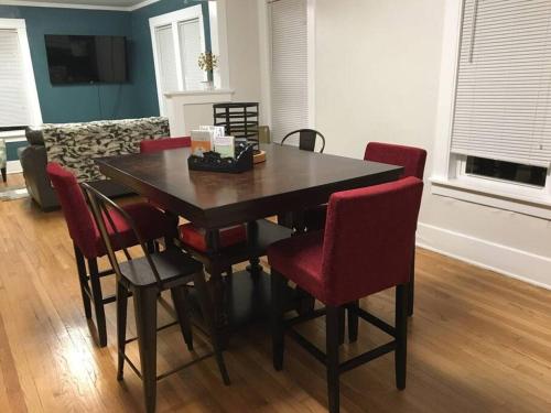 a dining room table and chairs in a living room at Center Midtown WalkUp in Omaha