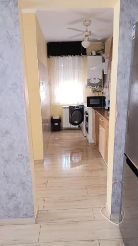a view of a kitchen from the hallway of a house at B&b Paralela 45 in Piatra Neamţ