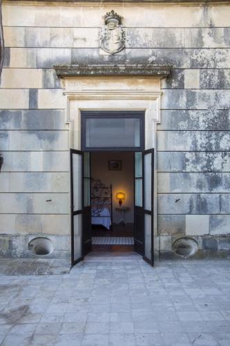a doorway into a building with a bed in it at Castello di Casamassella - Marea Stays Collection in Casamassella