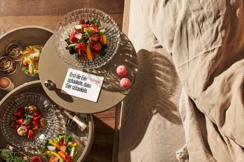 two plates of food sitting on a bed at Lieperts Cafe Dinner Rooms Boutiqe-Zimmer Südsteiermark in Leutschach