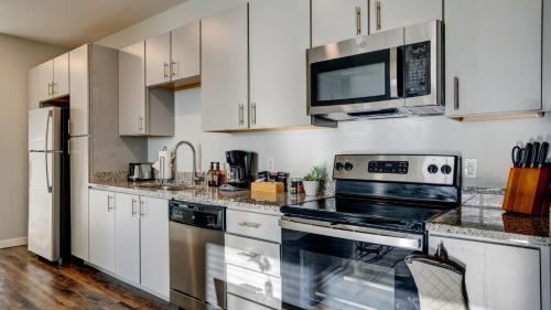 a kitchen with white cabinets and a stove top oven at Spacious 1Bedroom 1bath Heart of Redmond in Redmond