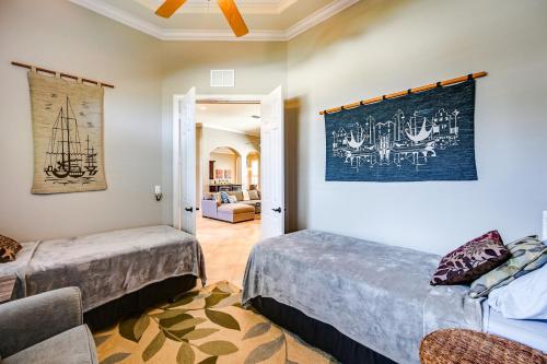 a bedroom with two beds and a living room at Marco Island Home with Private Pool 3 Mi Beach! in Marco Island