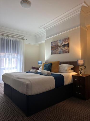 a bedroom with a large bed in a room at The New Brighton Hotel in New Brighton