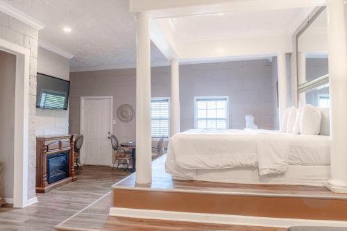 a bedroom with a large white bed and a table at Atlantis Inn - Tybee Island in Tybee Island